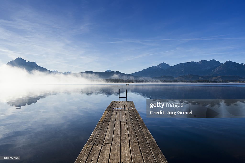 A wooden jetty on Lake Hopfensee at sunrise