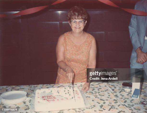 mom's birthday: vintage photograph of 1960s woman with birthday cake, vintage mother's birthday - happy birthday vintage fotografías e imágenes de stock