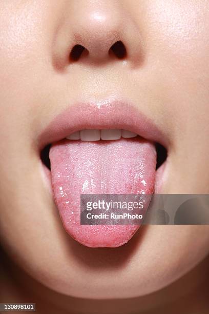 tongue of young woman,close-up - 人間の舌 ストックフォトと画像