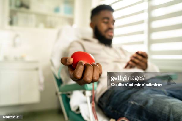 young man donating blood - donation stock pictures, royalty-free photos & images