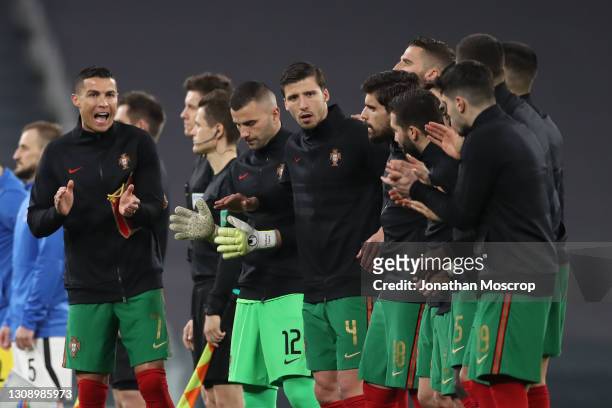 Cristiano Ronaldo of Portugal appaluds and shouts to encourage team mates prior to kick off following the national anthems during the FIFA World Cup...