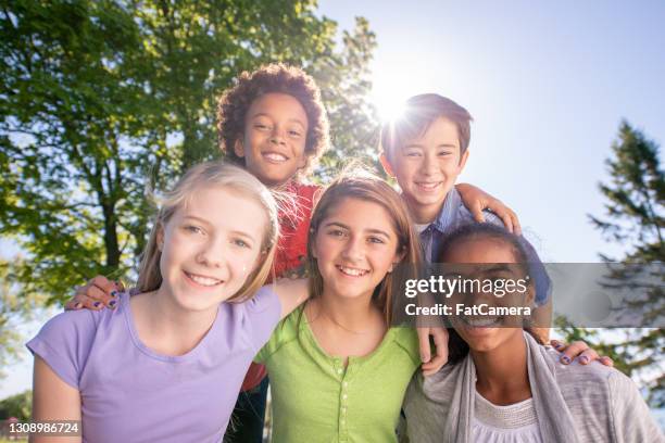 multi ethnic group of children posing for a photo outdoors - ymca summer camp stock pictures, royalty-free photos & images