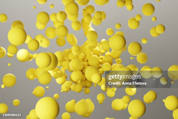 many yellow spheres splashing over gray background. demonstrating colors of the year 2021 - ultimate gray and illuminating - 球体　cg ストックフォトと画像