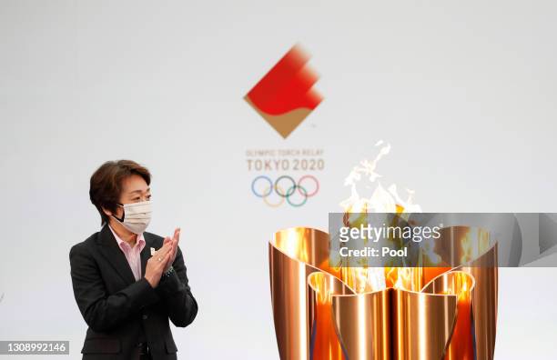 Tokyo 2020 President Seiko Hashimoto applauds next to the celebration cauldron during the opening ceremony ahead of the the first day of the Tokyo...
