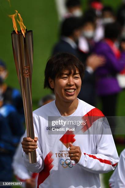 Azusa Iwashimizu, a members of Japan women’s National Football Team “Nadeshiko Japan” runs as a torchbearer in the first leg of the torch relay for...