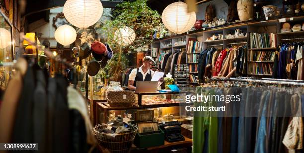 vintage shop owner - black hat stock pictures, royalty-free photos & images
