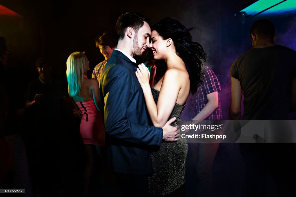 Couple dancing, getting close on the dance floor