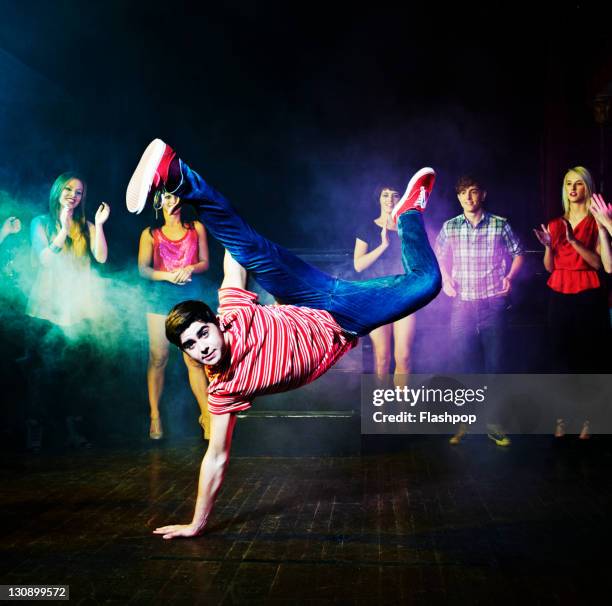 man dancing in front of a crowd of people - street dance stock pictures, royalty-free photos & images