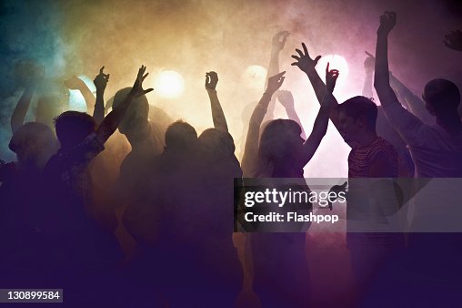 Crowd of people at concert waving arms in the air Crowd of people at concert waving arms in the air