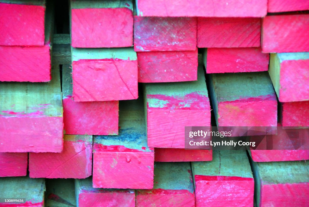 Planks of wood dipped in pink paint