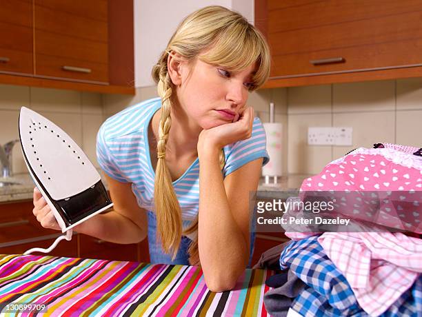 girl with iron doing chores - woman chores stock pictures, royalty-free photos & images