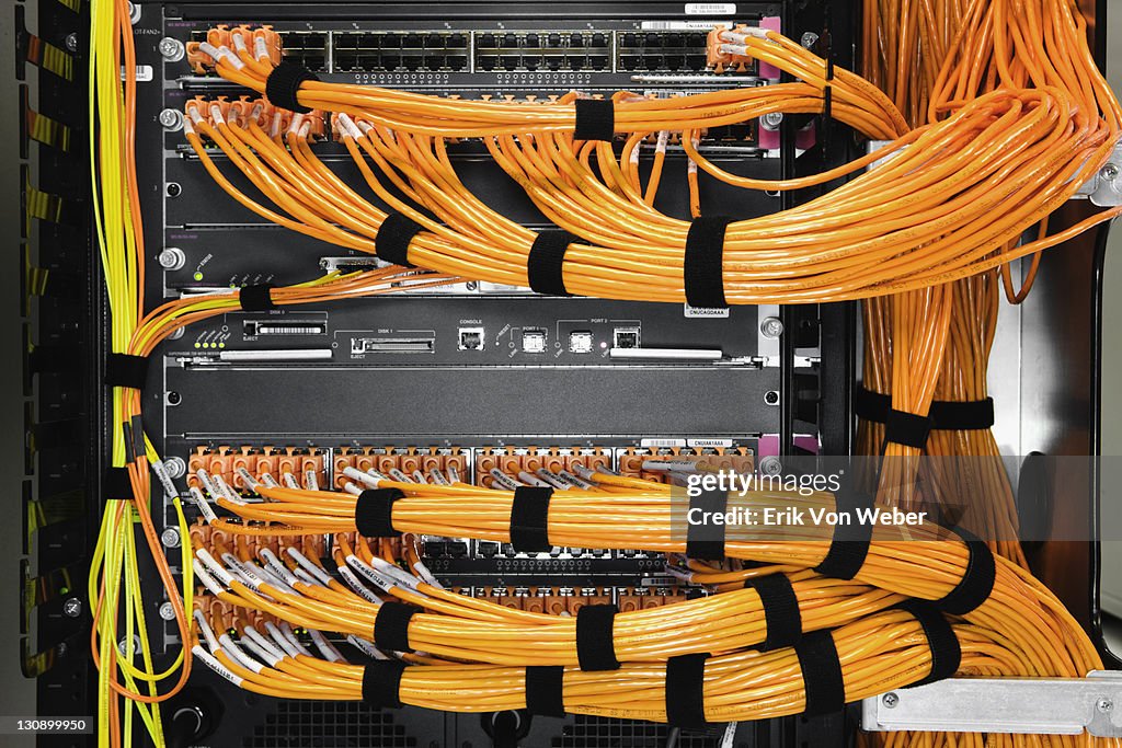 Detail of orange cables in a server room.