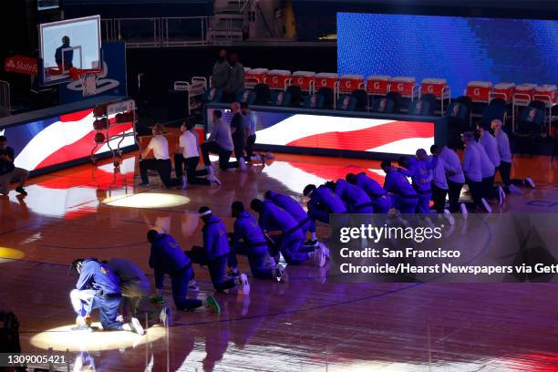 Golden State Warriors kneel during National Anthem before playing Los Angeles Clippers during NBA game at Chase Center in San Francisco, Calif., on...