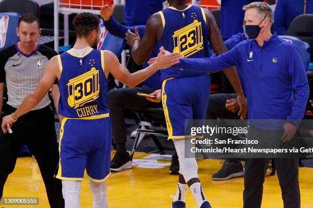 From left: Golden State Warriors guard Stephen Curry high fives Warriors head coach Steve Kerr as Curry is taken out for the game late in the fourth...