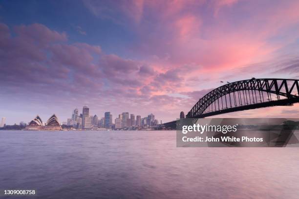 capital city of sydney at dusk. new south wales. australia. - hafenbrücke von sydney stock-fotos und bilder