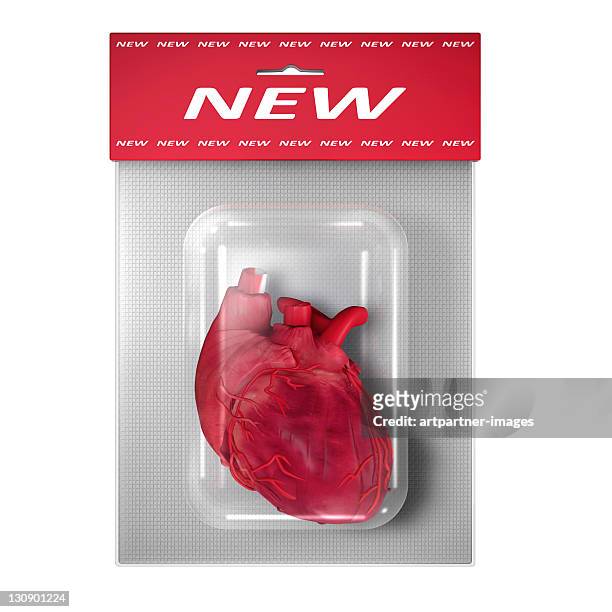 new (human) heart in a blister pack on white - transplant surgery stock-fotos und bilder