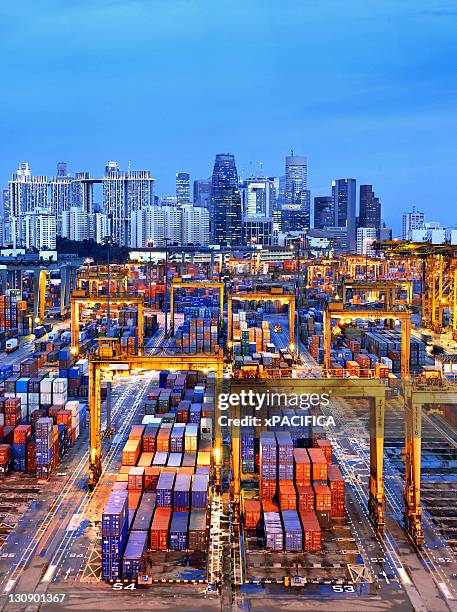 an evening view of a singapore container terminal - singapore port stock pictures, royalty-free photos & images