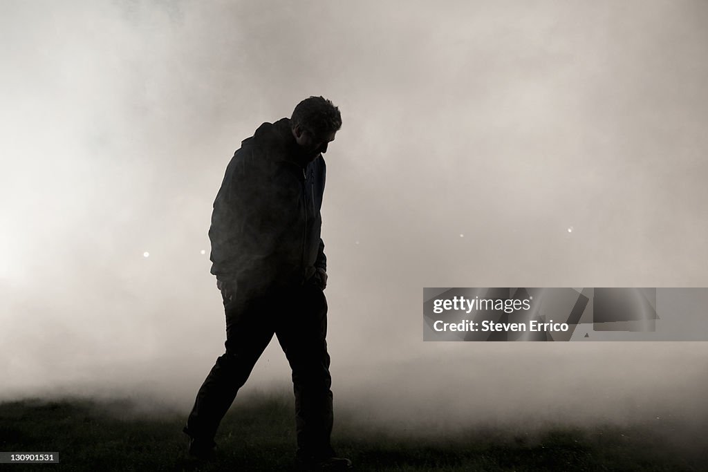 Man walking through fog