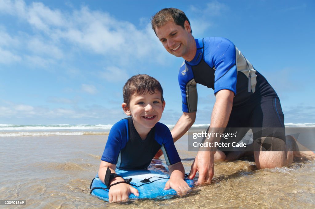 Fater and son on bodyboeard in sea