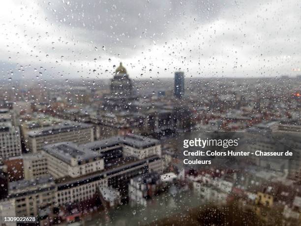 rainy day in brussels and drops on window - belgium stock-fotos und bilder