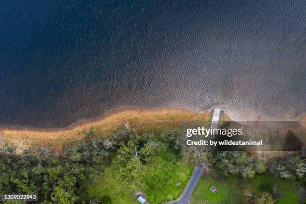 aerial view of a boat ramp at the water's edge of a lake, central coast area, nsw, australia. - boat launch stockfoto's en -beelden