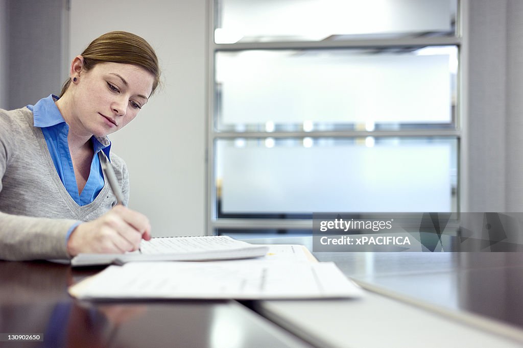 A young woman taking notes
