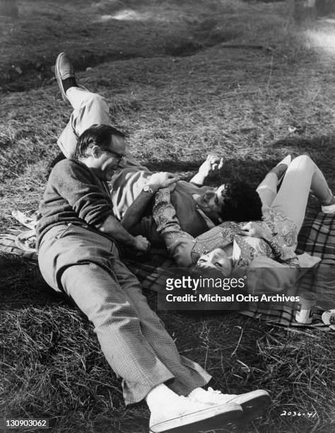 Director Mel Stuart discusses an upcoming scene with Elliott Gould and Brenda Vacarro for the film 'I Love My Wife', 1970.