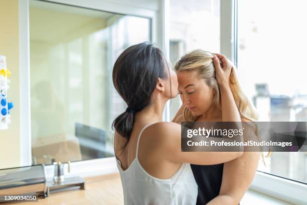 emotional moments for beautiful multi-ethnic lesbian couple who is hugging and kissing each other. - asian lesbians kiss stock pictures, royalty-free photos & images