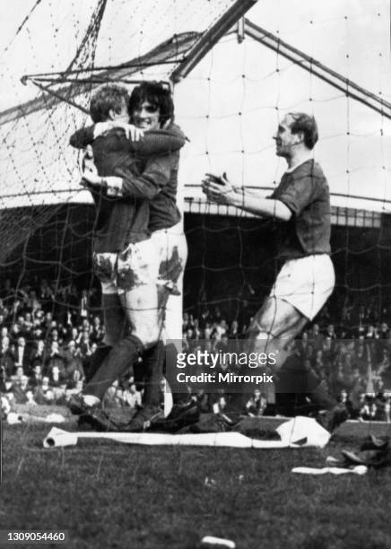 Denis Law of Manchester United is congratulated on his goal by jubilant teammates George Best and Bobby Charlton during an FA Cup Fifth Round match...