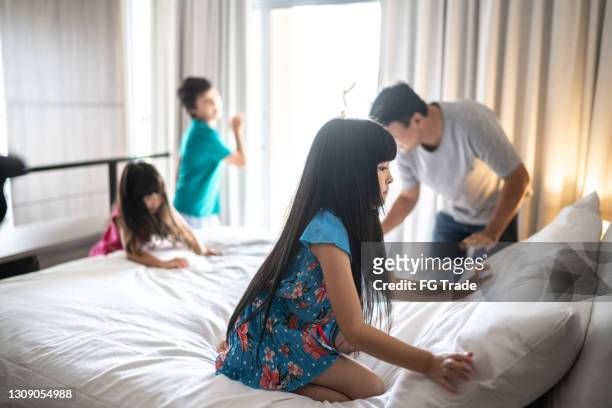 family doing the bed together at home - mother and daughter making the bed stock pictures, royalty-free photos & images