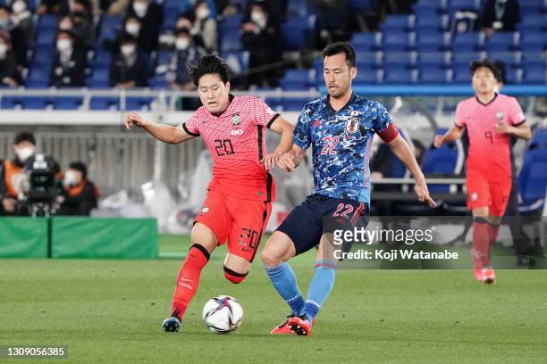Lee Kangin of South Korea and Maya Yoshida of Japan compete for the ball during the international friendly match between Japan and South Korea at the...