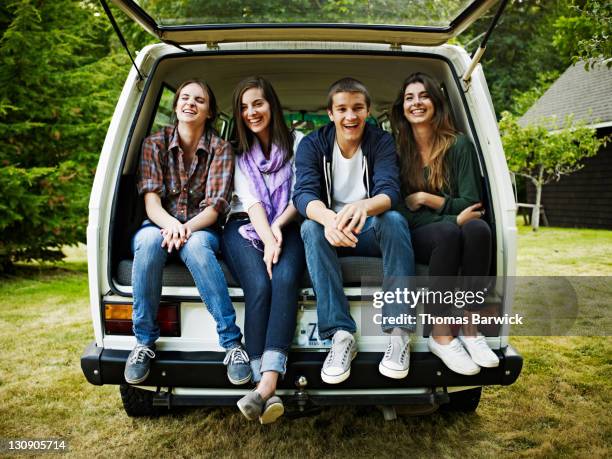 group of teen friends sitting in rear of van - car logs stock pictures, royalty-free photos & images