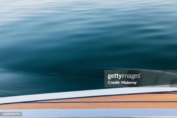 speed: blurred motion water from moving motor boat at lake chiemsee. - motor yacht stockfoto's en -beelden