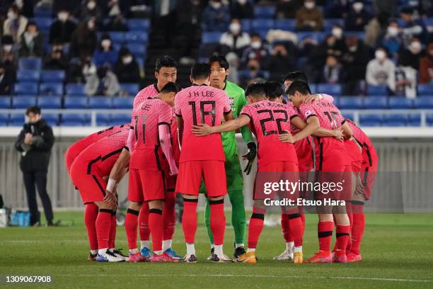 South Korean players huddle at the start of the second half during the international friendly match between Japan and South Korea at the Nissan...