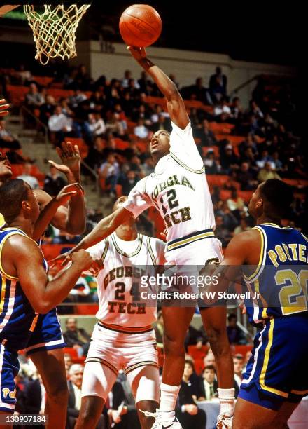 Georgia Tech's star point guard Kenny Anderson goes high for a rebound against the University of Pittsburgh in a game pitting the Atlantic Coast...