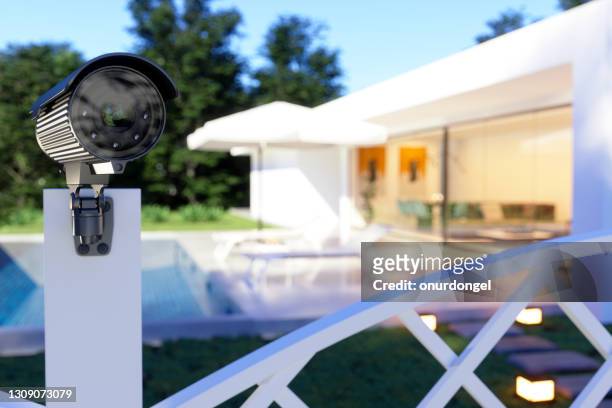 exterior of a villa with security camera at the entrance of the garden. - security camera stock pictures, royalty-free photos & images