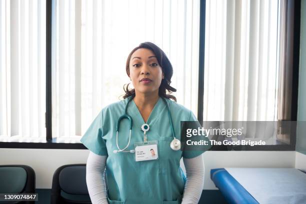 portrait of female nurse standing in hospital exam room - nurse portrait stock pictures, royalty-free photos & images