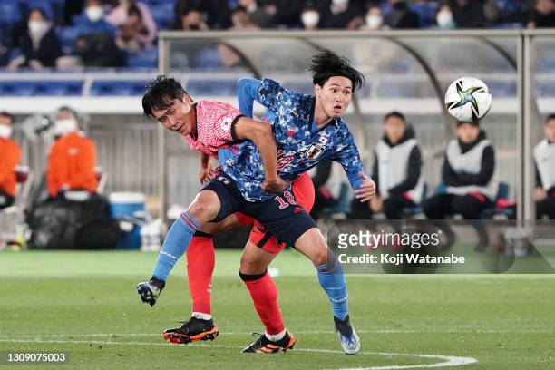 Takumi Minamino of Japan and Won Dujae of South Korea compete for the ball during the international friendly match between Japan and South Korea at...