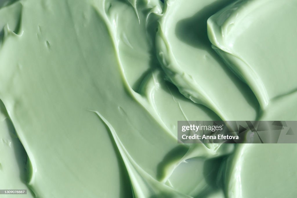 Texture of pastel turquoise cream. Herbal medicine and alternative therapy concept. Selfcare is a trend of the year. Cosmetics banner with copy space