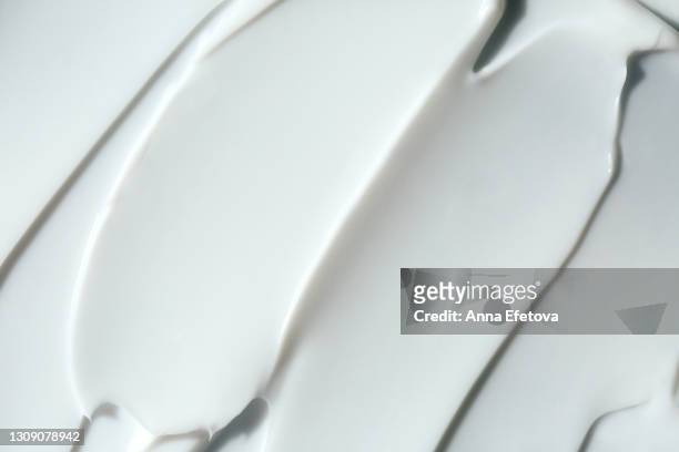 abstract and accurate texture of white cream. it may be self care concept or perfect food background. selfcare is a trendy procedure of the year. cosmetics banner with copy space - creme stock-fotos und bilder