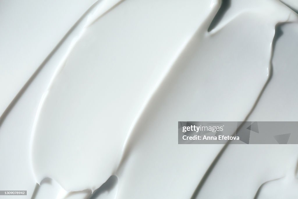 Abstract and accurate texture of white cream. It may be self care concept or perfect food background. Selfcare is a trendy procedure of the year. Cosmetics banner with copy space