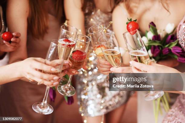 beautiful young women's hands hold glasses of champagne. women's party - bridesmaid stock pictures, royalty-free photos & images