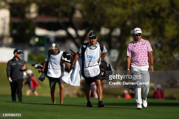 Hideki Matsuyama of Japan walks up the first fairway in his match against Brian Harman of the United States during the second round of the World Golf...