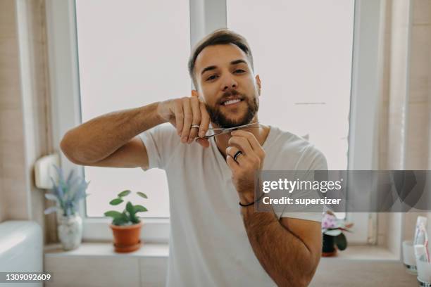 beautiful young man getting ready in the morning - beard trimming stock pictures, royalty-free photos & images