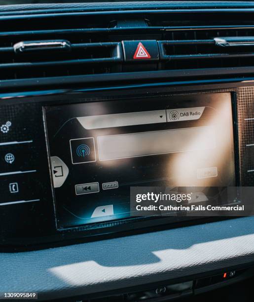 a digital display screen on the dashboard of a modern car, from an vehicle interior point of view - bluetooth car stereo stock pictures, royalty-free photos & images