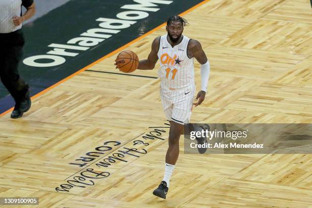 James Ennis III of the Orlando Magic dribbles the ball against the Phoenix Suns at Amway Center on March 24, 2021 in Orlando, Florida. NOTE TO USER:...