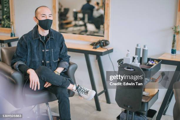 asian chinese hairstylist owner of hair salon looking at camera smiling confidence with face mask - best beauty salon stock pictures, royalty-free photos & images