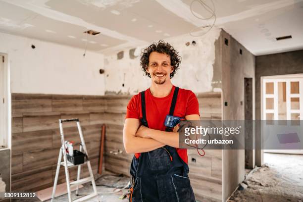 smiling electrician renovating house - replacement stock pictures, royalty-free photos & images