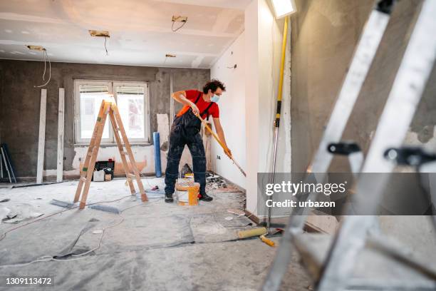 man painting apartment walls - decorating stock pictures, royalty-free photos & images