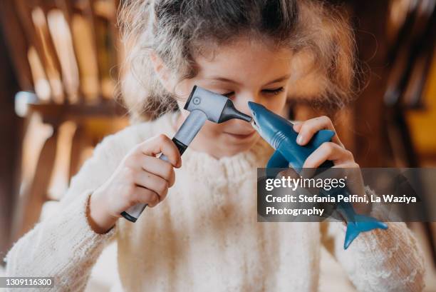 little girl pretending to be a veterinary - toy animal stockfoto's en -beelden